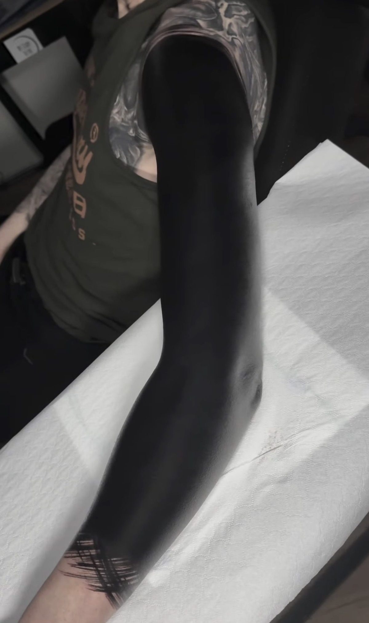 Solid blackwork covering the full arm, black and grey realism tattoo by Ruby Ink